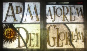 Medieval glass & lead window with the text: Ad Majorem Dei Gloriam