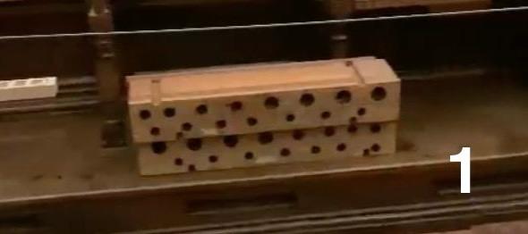 Houten onderdeel van een orgelwindlade met rijen openingen waardoor de orgelwind naar verschillende pijpen wordt geleid.